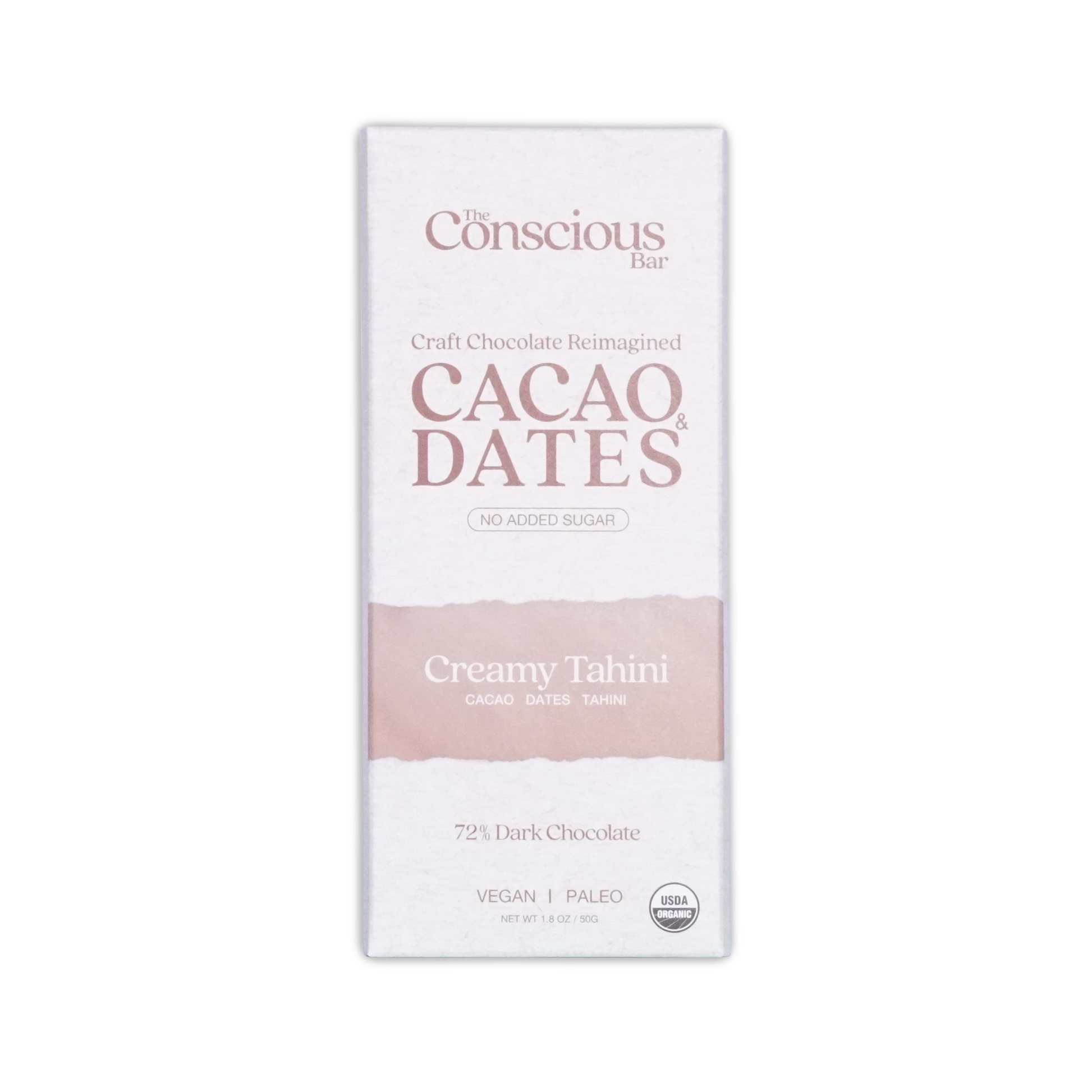 A white rectangular package of the conscious bar dark creamy tahini 72 percent cacao and dates chocolate bar with pink stripe