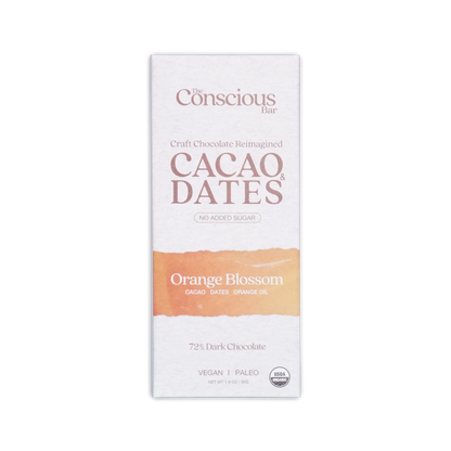 The conscious bar dark orange blossom 72 percent cacao and dates chocolate bar in white and peach minimalist wrapper