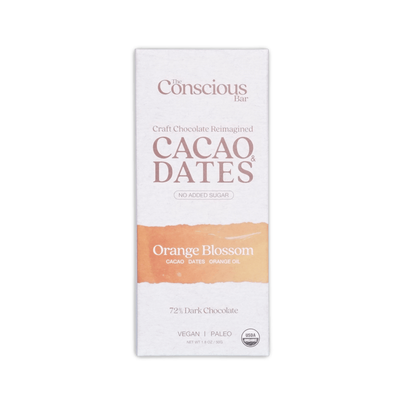 The conscious bar dark orange blossom 72 percent cacao and dates chocolate bar in white and peach minimalist wrapper