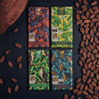 Four Theo & Philo dark bars with cacao beans.