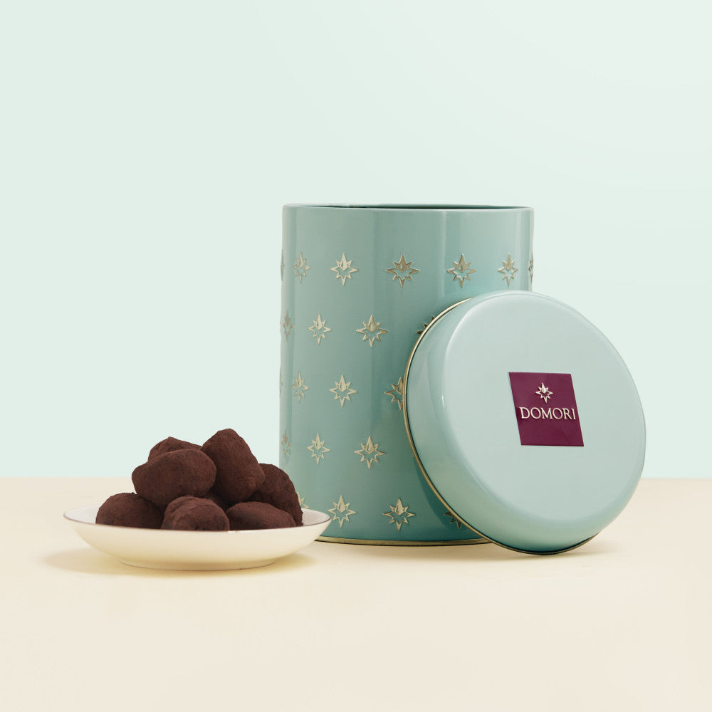 Domori Classic Truffles & Napolitains teal tin with gold stars and logo lid