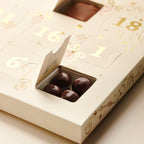 Close-up of open windows in the Valrhona 2026 Advent Calendar showing chocolate-coated nuts