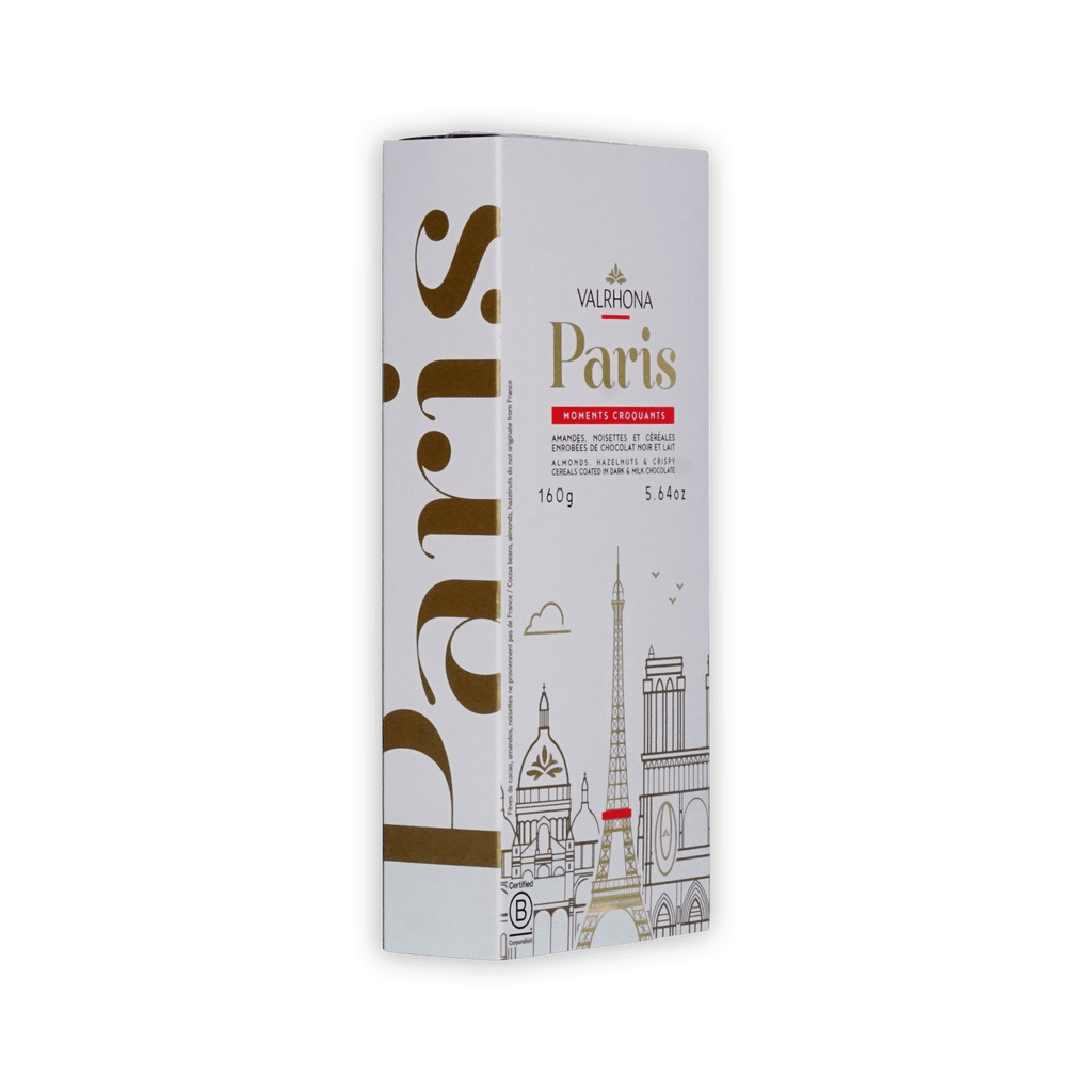 Valrhona Paris box at an angle, white with gold Paris lettering and skyline, almonds, hazelnuts and cereals in dark and milk chocolate, 160g