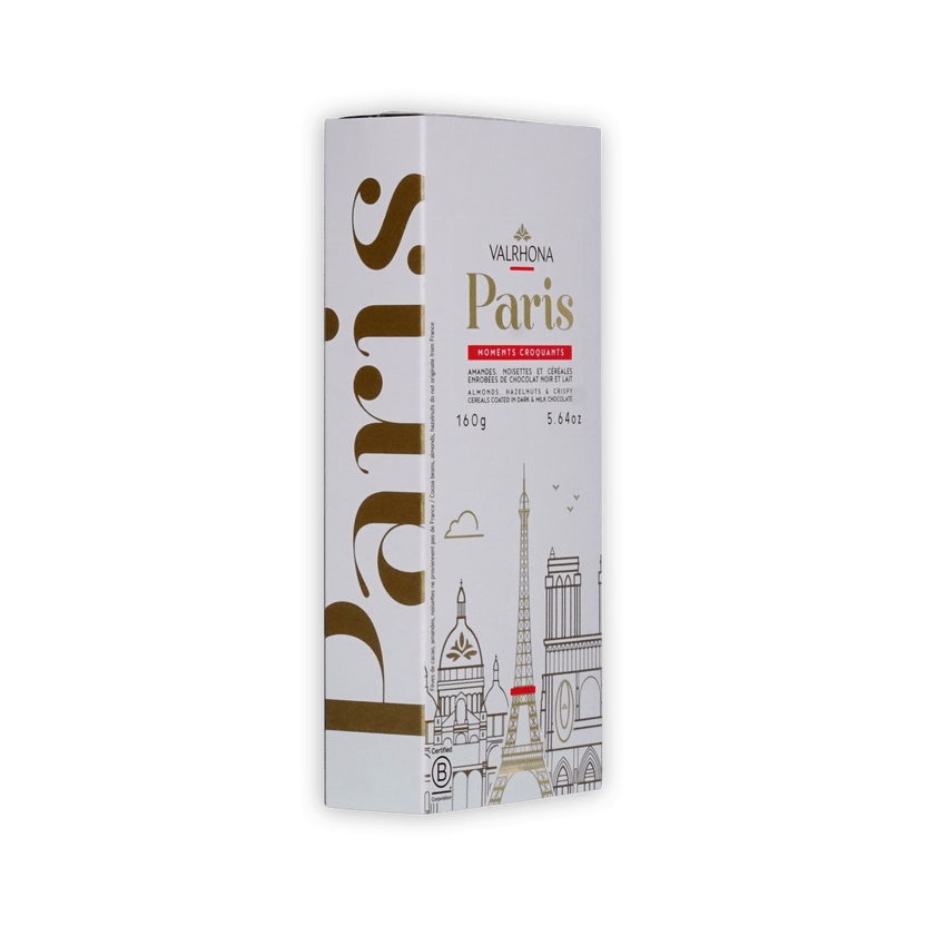Valrhona Paris box at an angle, white with gold Paris lettering and skyline, almonds, hazelnuts and cereals in dark and milk chocolate, 160g