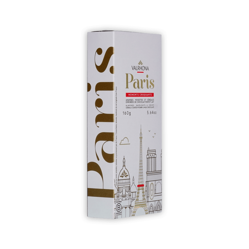 Valrhona Paris box at an angle, white with gold Paris lettering and skyline, almonds, hazelnuts and cereals in dark and milk chocolate, 160g