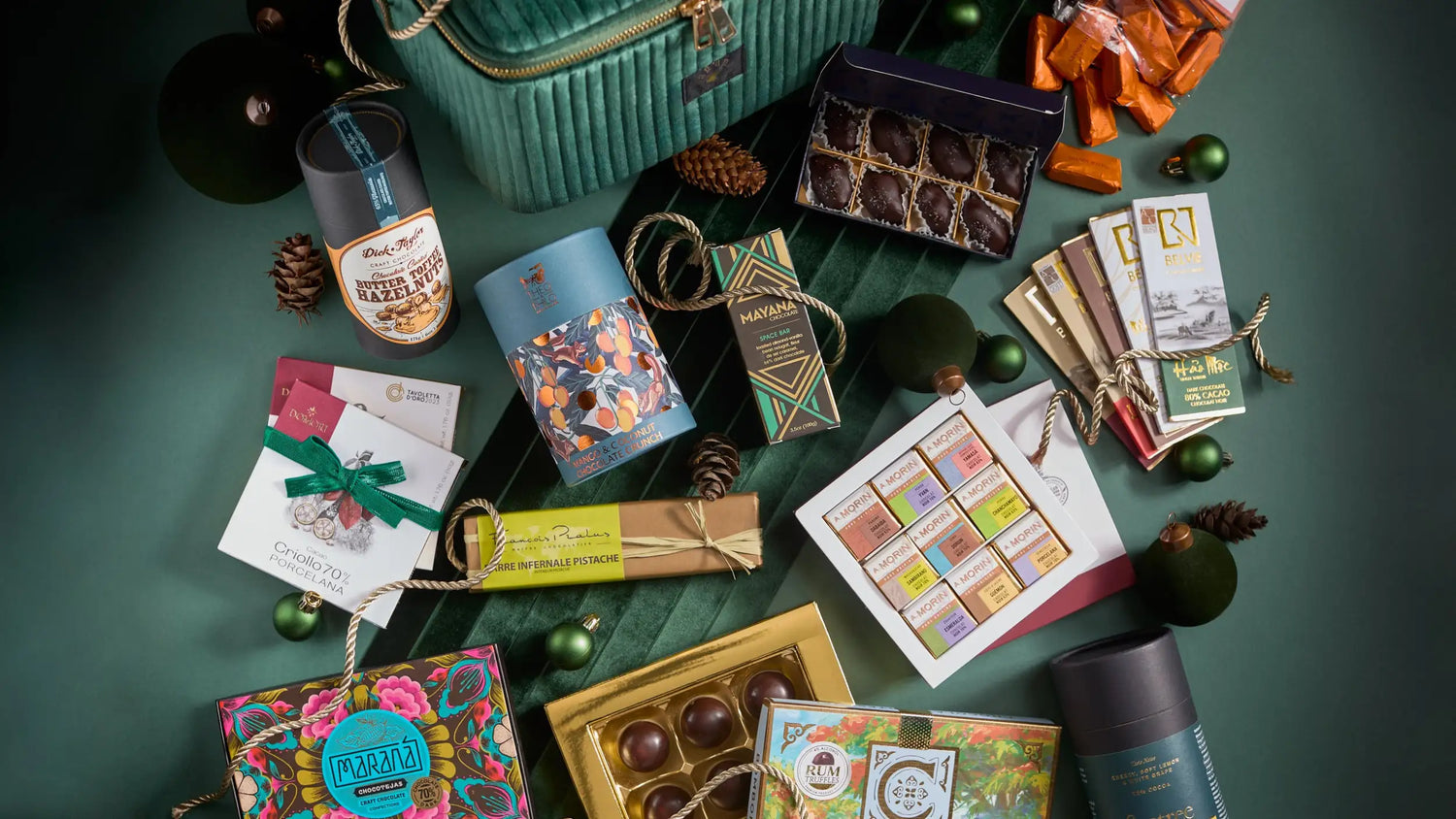 A teal velvet-lined gift box with gold zipper and handles.