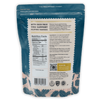 Auro 32% white chocolate coins in teal cream resealable pouch with leaf pattern