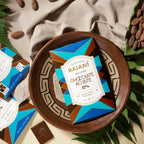 Baiani Dark Milk 57% chocolate bar wrapper in wooden bowl