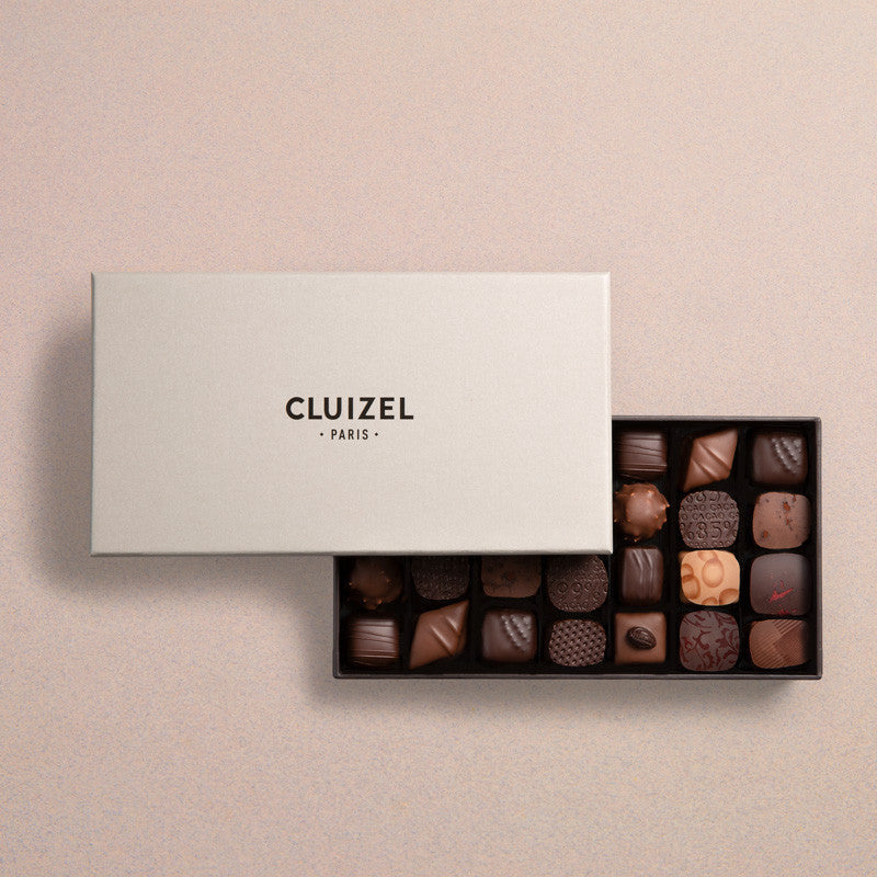 Michel Cluizel 28-piece chocolate bon bons gift box, open with assorted dark and milk chocolates
