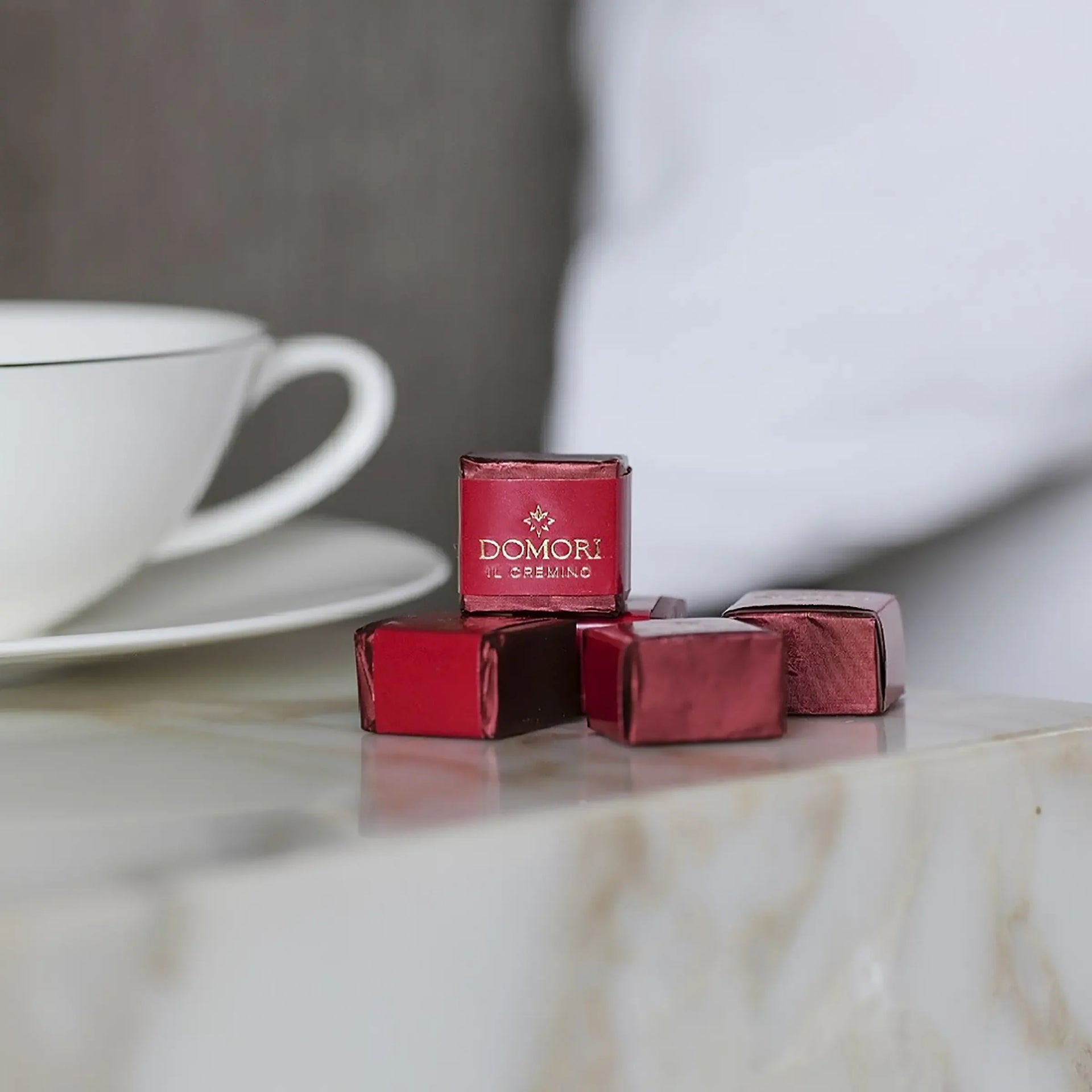 Red foil-wrapped Domori Il Cremino square chocolates in Classic Gianduja Cremino Bag