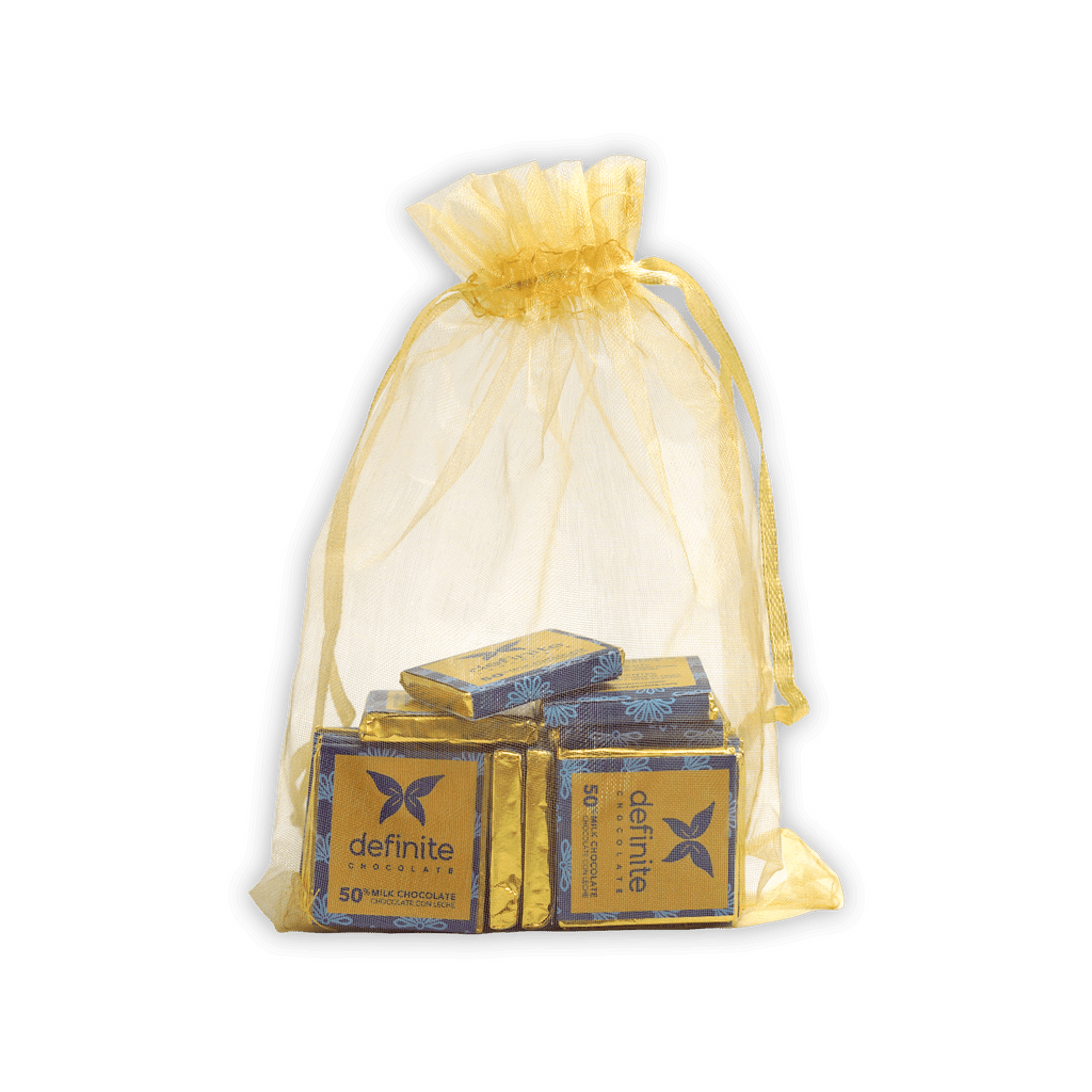 Sheer yellow organza bag with drawstring holding wrapped Definite Chocolate Napolitans mini squares