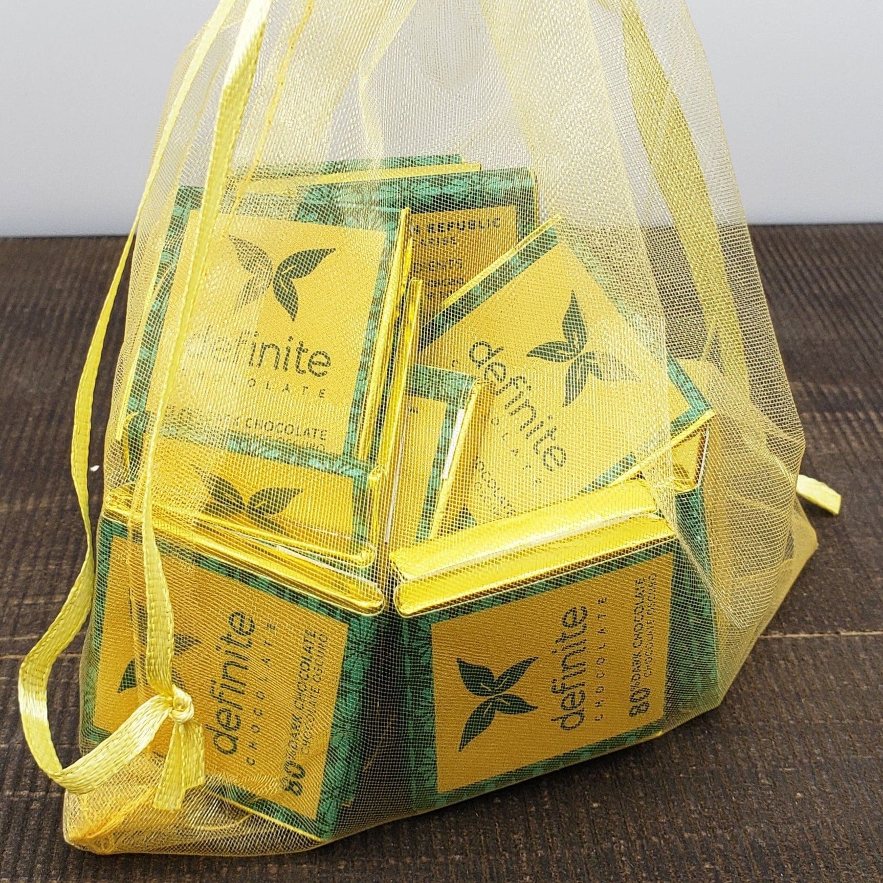 Yellow mesh drawstring bag with Definite Chocolate Napolitans mini squares
