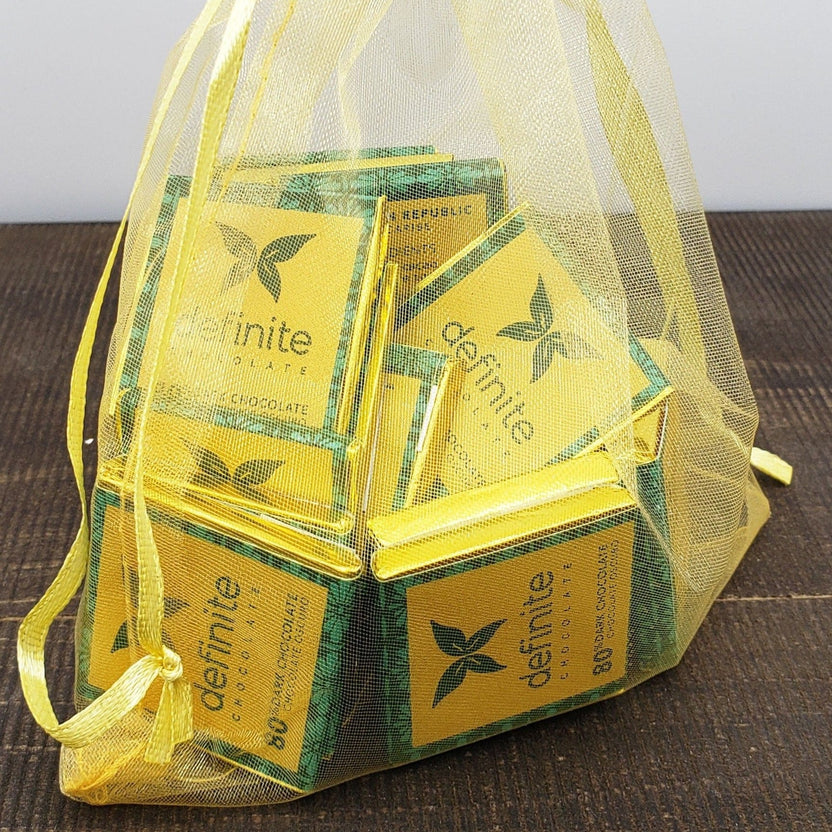 Yellow mesh drawstring bag with Definite Chocolate Napolitans mini squares