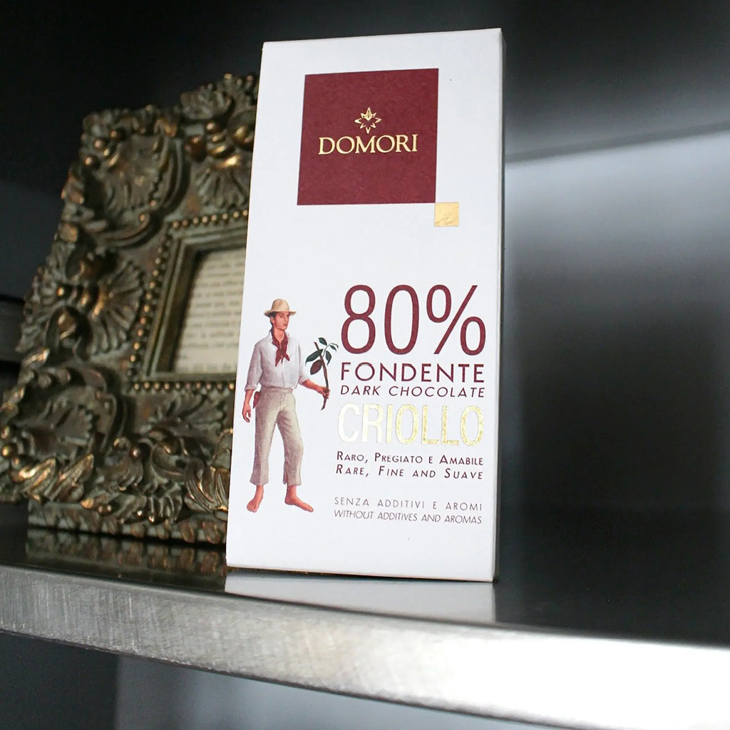 Domori Criollo 80% dark chocolate bar in white rectangular package with maroon logo