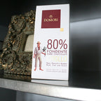 Domori Criollo 80% dark chocolate bar in white rectangular package with maroon logo