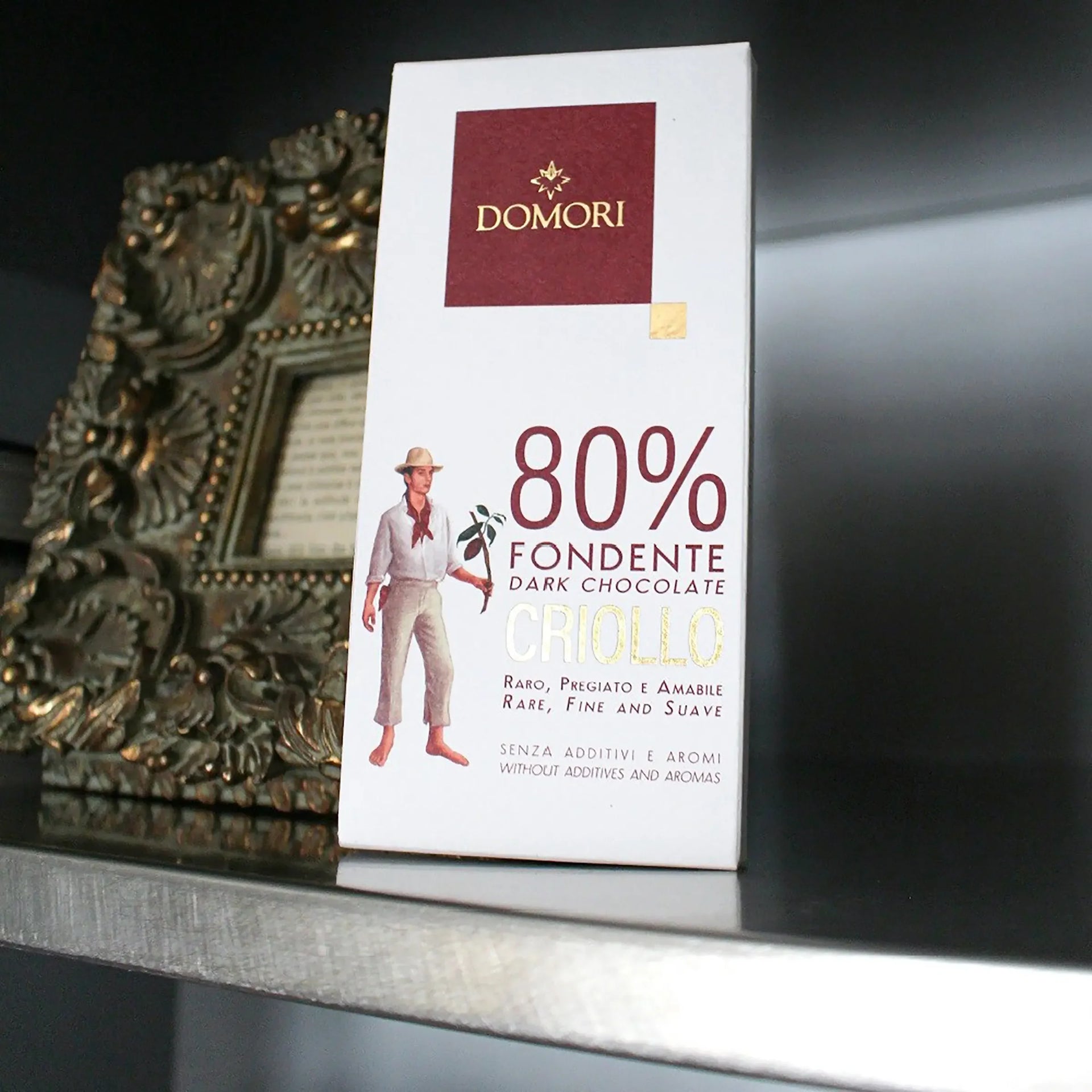 Domori Criollo 80% dark chocolate bar in white rectangular package with maroon logo