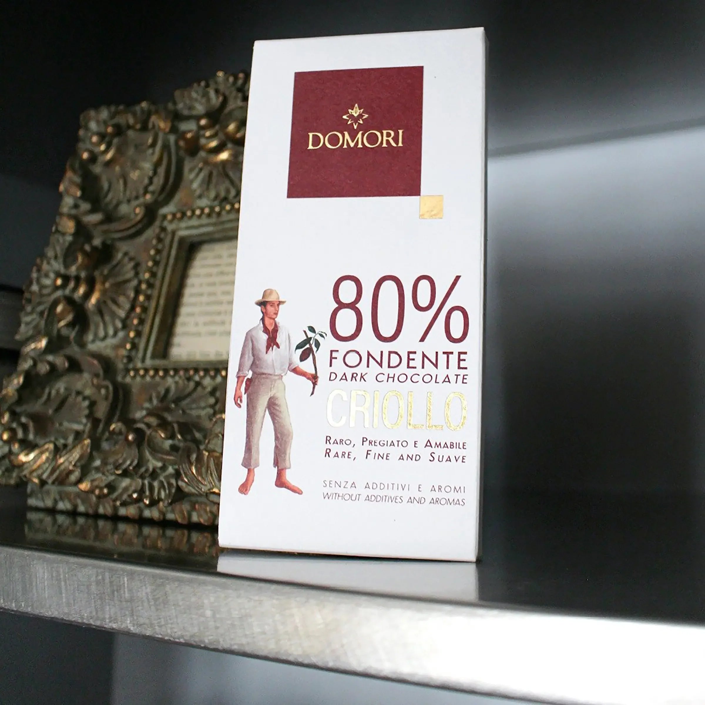 Domori Criollo 80% dark chocolate bar in white rectangular package with maroon logo