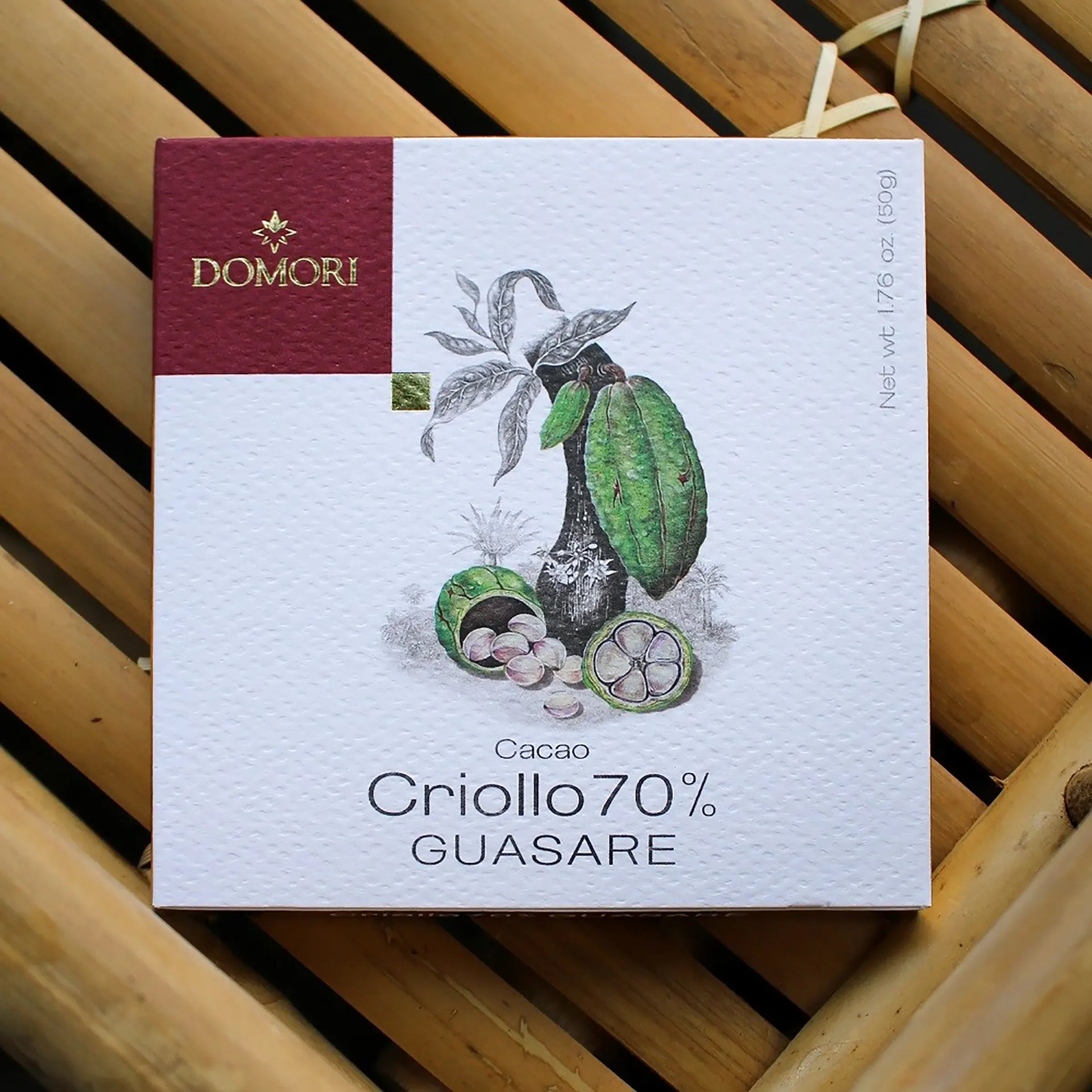 Domori Guasare Criollo 70% cacao bar in white maroon box with cocoa pods