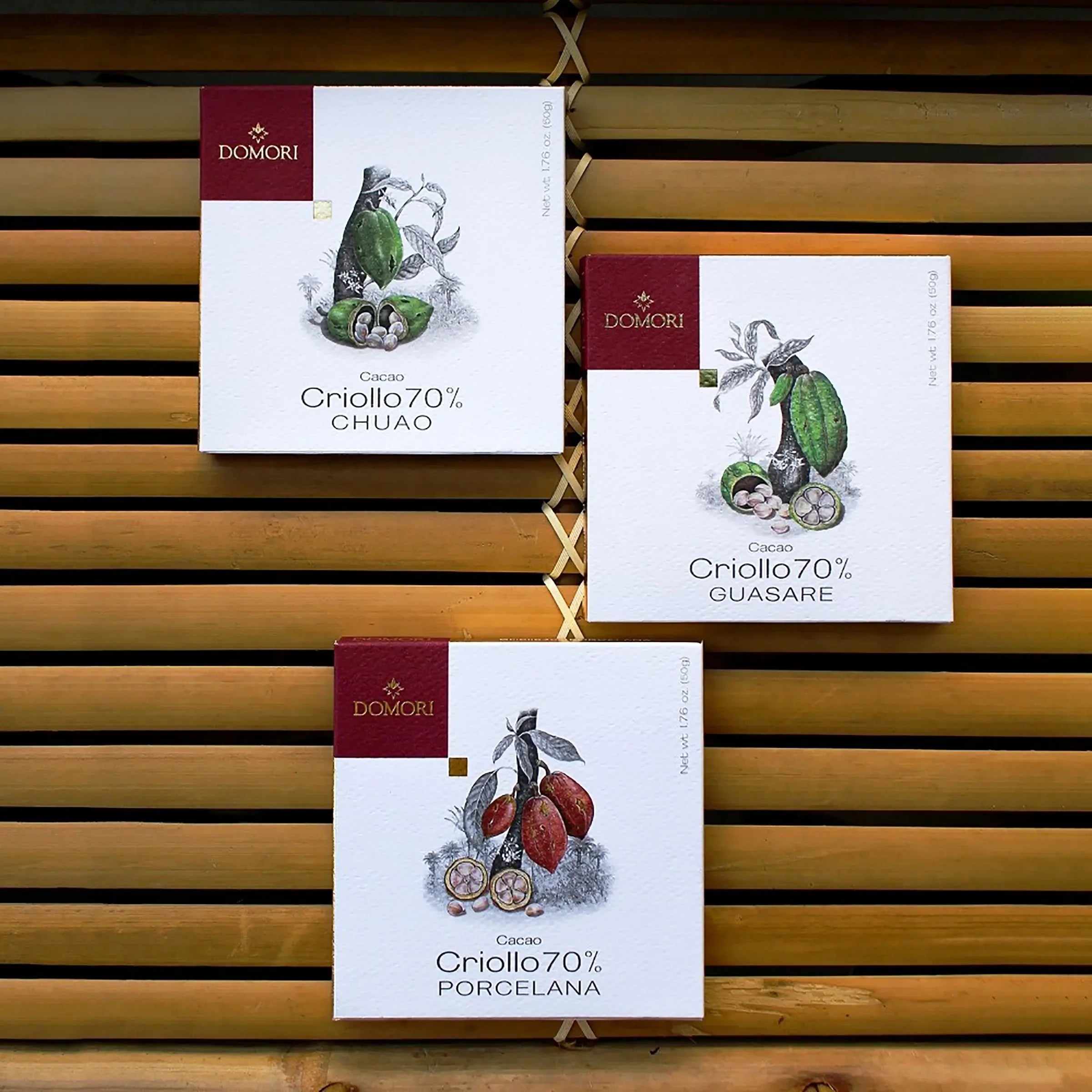 Three Domori Criollo 70% cacao boxes with origins, cocoa pod designs