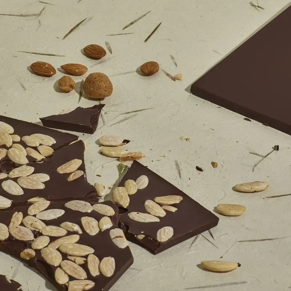 Domori Quantum 68% dark chocolate bar with whole almonds, glossy surface