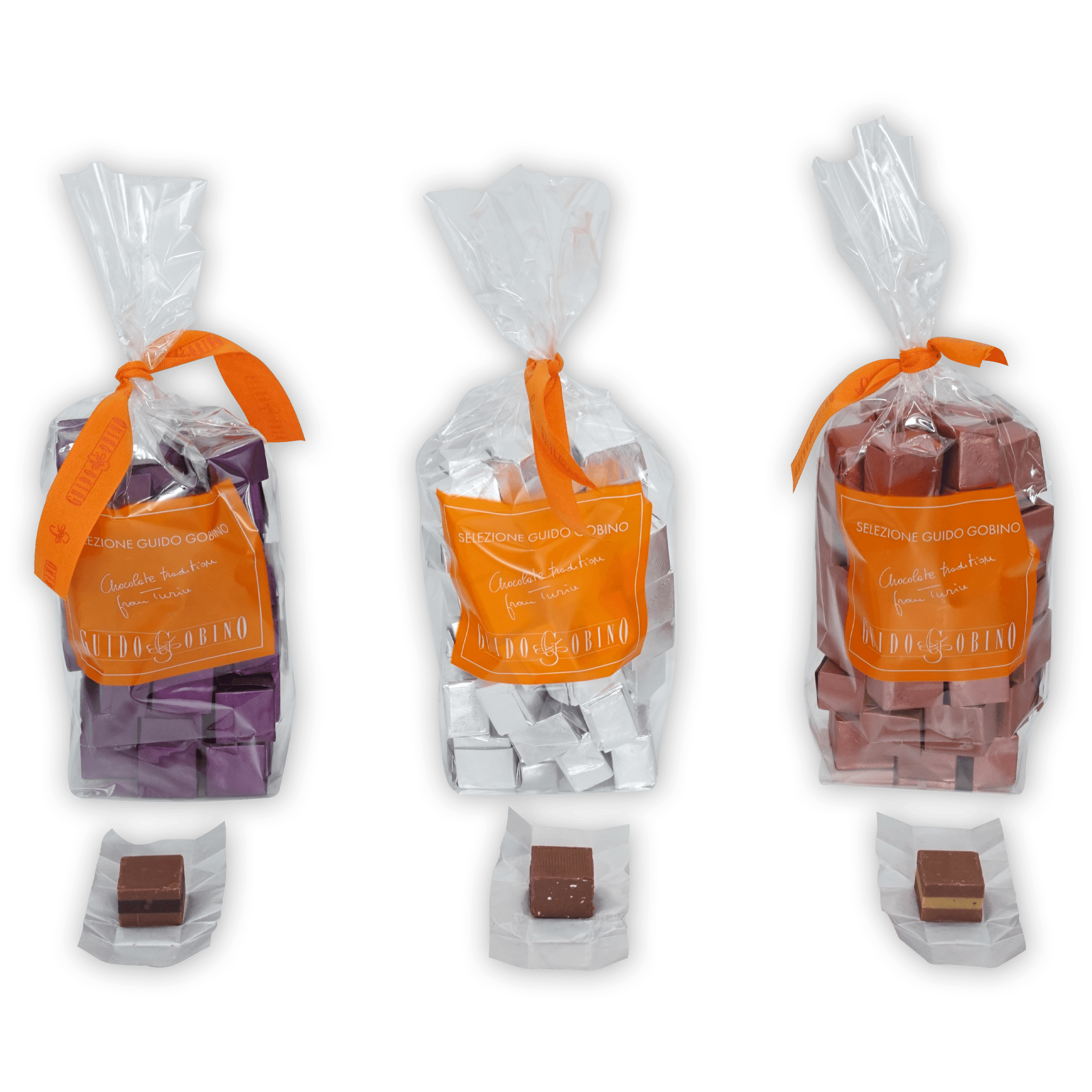 Three Guido Gobino Cremino bags with orange ribbons and chocolates