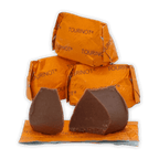 Two Guido Gobino Tourinot Classico dark chocolate pieces on orange foil