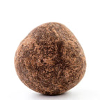 Soma dark chocolate covered hazelnut truffle, earthy-brown textured surface
