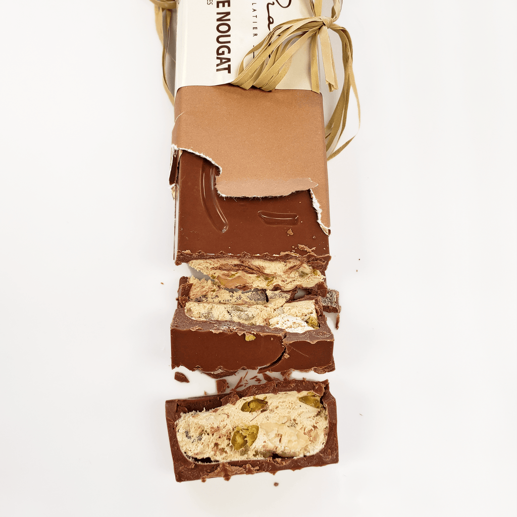 Pralus Infernale Nougat Bar partially unwrapped with pistachios