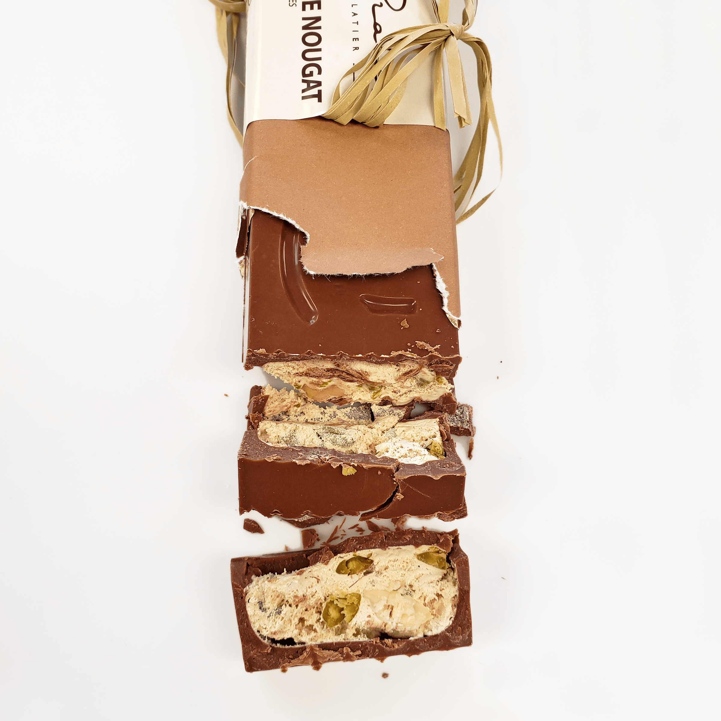 Pralus Infernale Nougat Bar partially unwrapped with pistachios