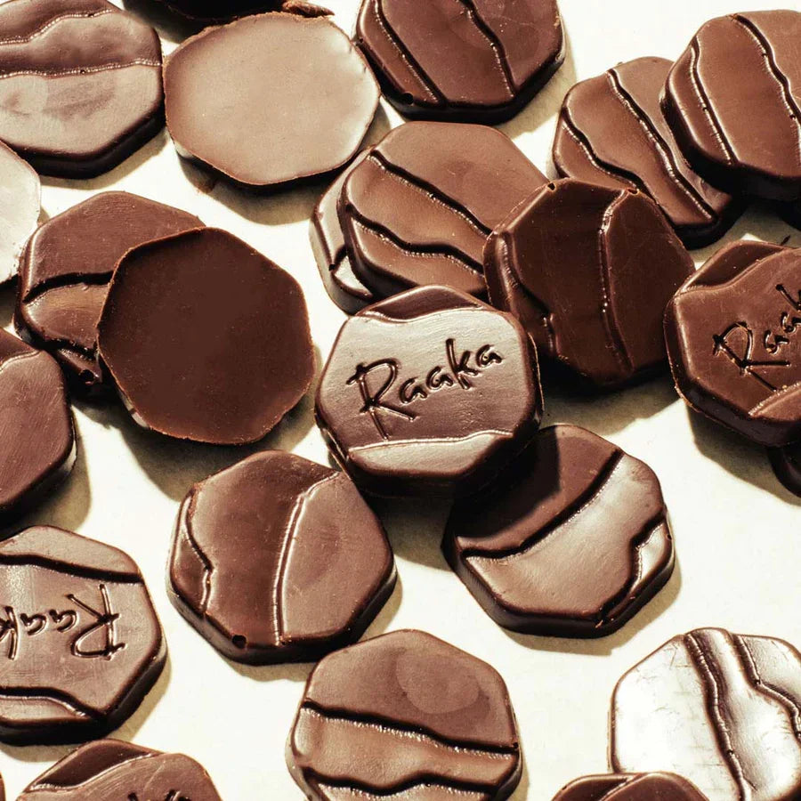 Raaka Maple Dark 75% Baking Chocolate glossy coins with Raaka branding