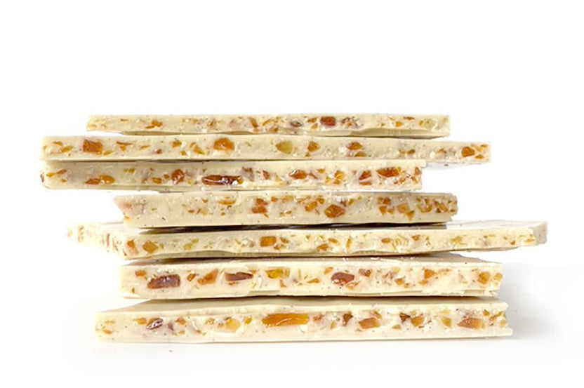 Stack of Soma Bark Crème Brûlée white chocolate bars with nuts and fruit, 125g