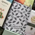 The Chocolate Notebook with cocoa pod line art on white cover